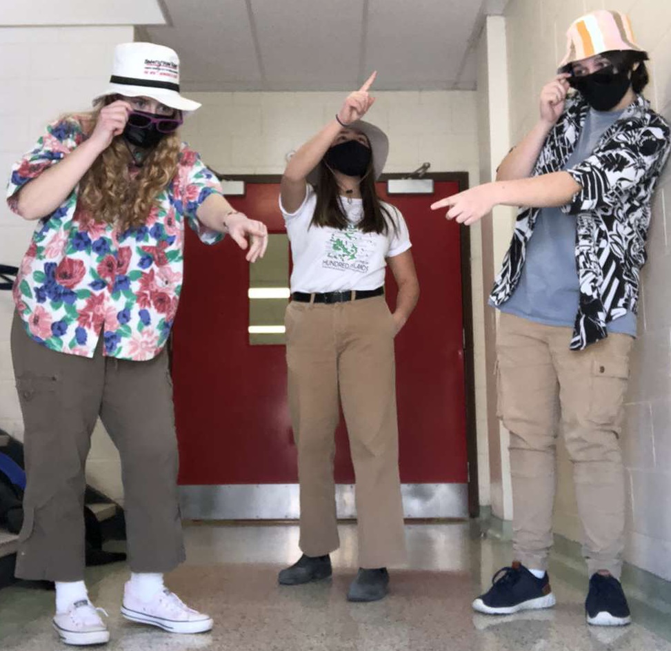 3 students in tourist clothing