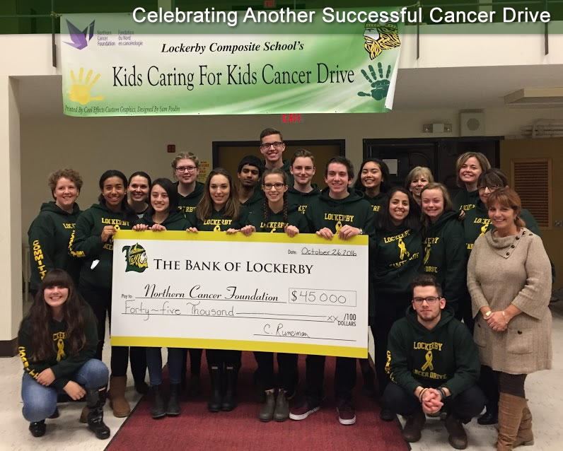 Group of students holding a giant cheque